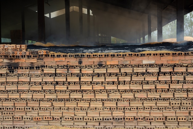 Stacks of fired bricks on a kiln factory floor