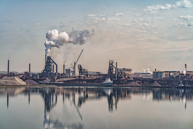 Steel mill with blast furnaces and material yards on the waterfront