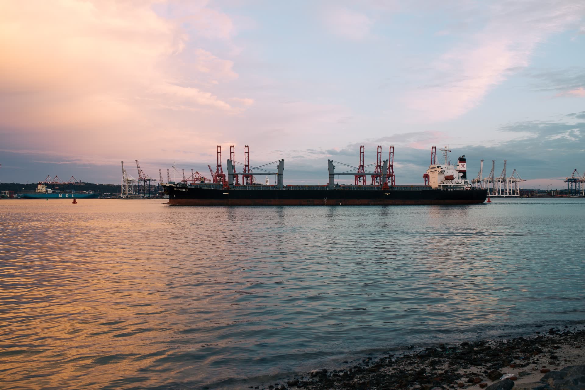 Cargo vessel at dusk, closing the global operations story